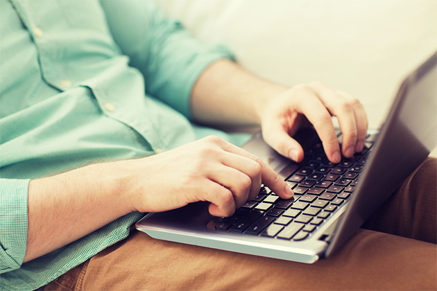 Connect with members on Cruise Critic (Photo: Syda Productions/Shutterstock) Man typing on laptop