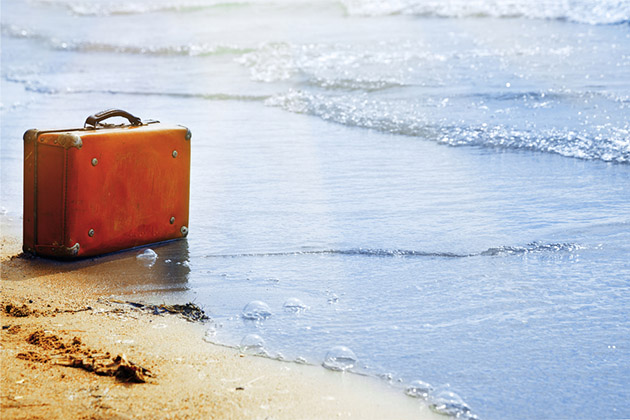 Solving problems onboard: luggage (Photo: Arman Zhenikeyev/Shutterstock) lone suitcase lost on the beach