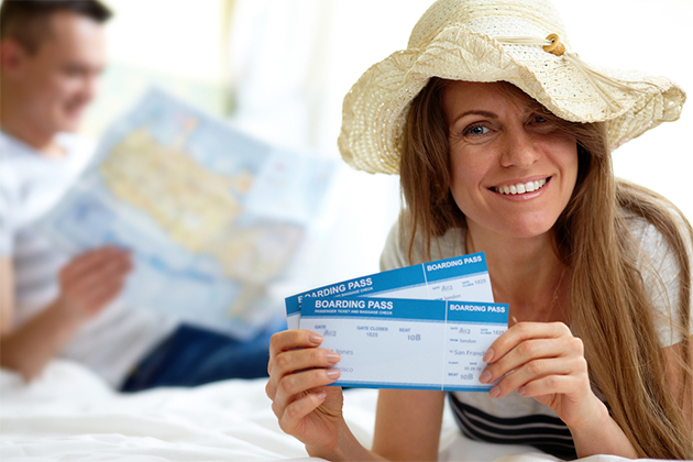 Unusual ways to book a cruise (Photo: Pressmaster/Shutterstock) Woman holding her boarding passes