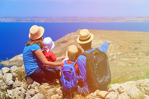 Family With Two Kids Looking at Map in Mountains (Photo: Nadezhda1906/ Shutterstock) Family With Two Kids Looking at Map in Mountains