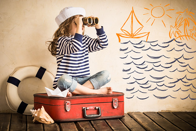 Happy kid playing with toy sailing boat indoors (Photo: Sunny studio/ Shutterstock) Kid Playing with toy sailing boat indoors