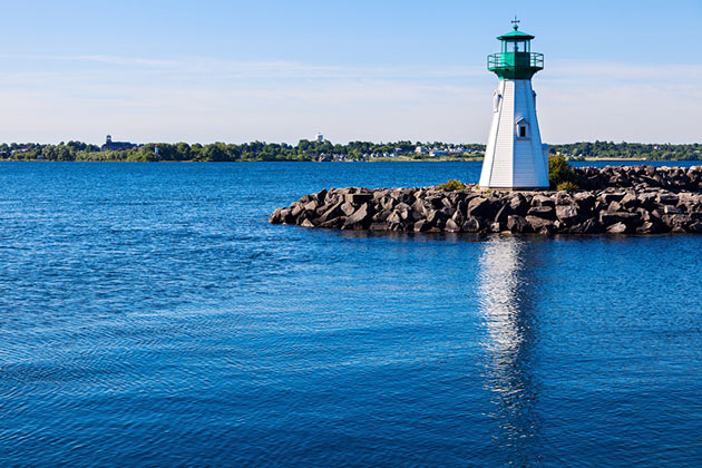 Lighthouse on St. Lawrence River (Photo: Henryk Sadura/ Shutterstock) Prescott Heritage Harbour Lighthouse and Ogdensburg, Vermont view accross St. Lawrence River. Prescott, Ontario, Canada.