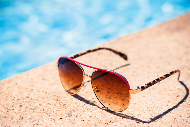 Pack a pair of sunglasses (Photo: Cristi Kerekes/Shutterstock) Brown funky sun glasses near swimming pool