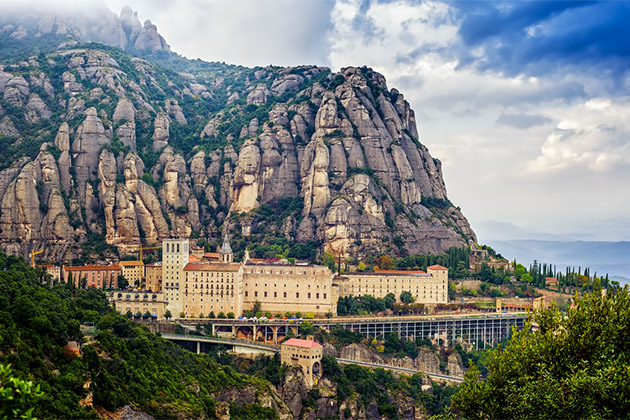 Benedictine monastery of Santa Maria de Montserrat (Photo: Tania Zbrodko/Shutterstock) Santa Maria de Montserrat monastery in the mountains