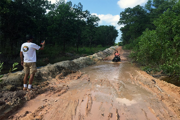 Driving down a muddy road (Photo: Chris Gray Faust) Quad bike driving down muddy road