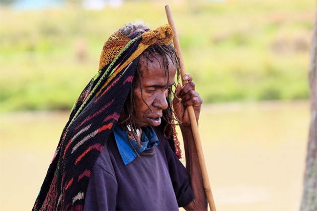 Indonesian native (Photo: Olga Yarovenko/Shutterstock) Dani woman in a traditional dress, cap on a head