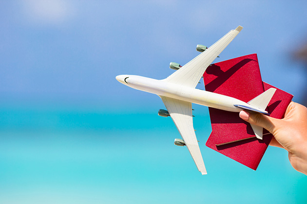 Switch Flight (Photo: TravnikovStudio/ Shutterstock) Closeup of passports and white miniature airplane background the turquoise sea