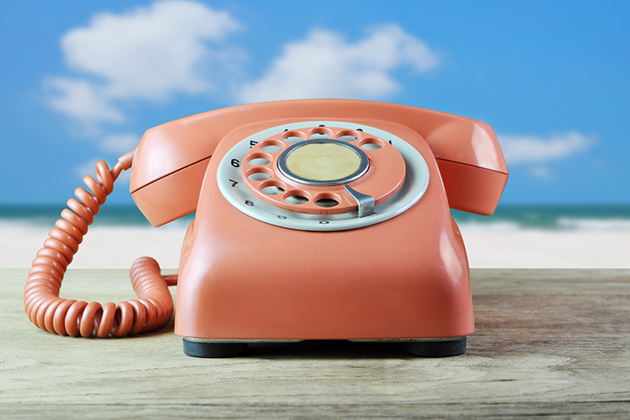 Contact Your Cruise Line (Photo: Love the wind/ Shutterstock) Vintage phone with a beach in the background