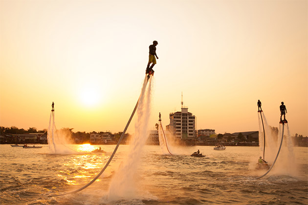 Flyboarders at sunset (Photo: Suwan Wanawattanawong/Shutterstock) Silhouettes of flyboarders at sunset