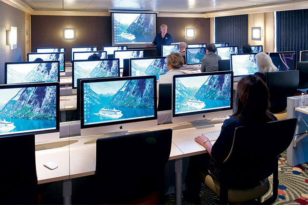 Crystal's University@Sea program (Photo: Crystal Cruises) Man lecturing at Crystal's computer lab for University@Sea