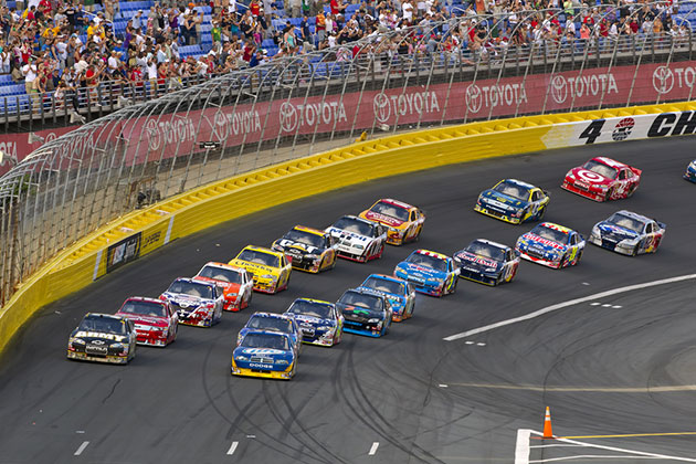 Nascar Race (photo: Action Sports Photography/Shutterstock) Race cars round turn on track with fans in the background