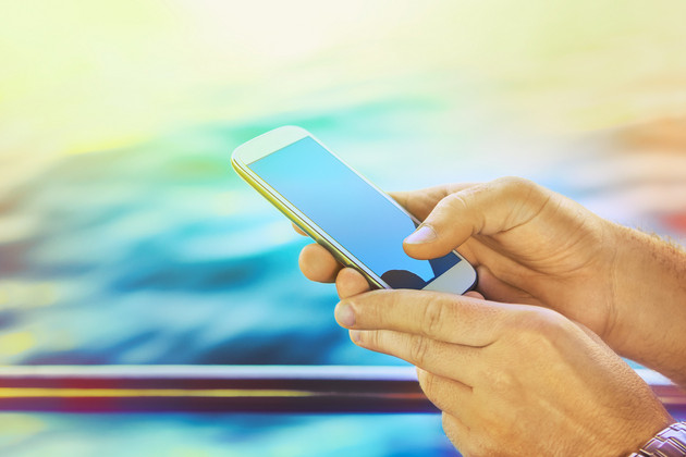 Cruise line internet and cell phone policies (photo: carol.anne/Shutterstock) using a cell phone on a cruise