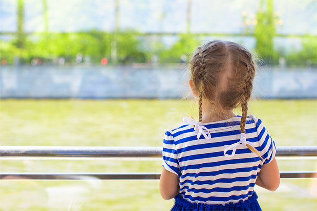 Little girl onboard a river vessel (Photo: TravnikovStudio/Shutterstock) Little girl looking over the river from luxury ship