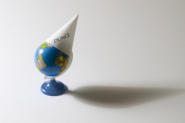 Avoid these dumb travel mistakes on your next cruise. (photo: Ken Tannenbaum/Shutterstock.com) dunce cap on toy globe
