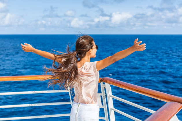 Stay healthy on your cruise (Photo: Maridav
/Shutterstock) Woman enjoying travel vacation at sea