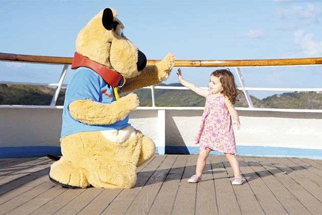 Child passenger with Thomson the Dog (Photo: Thomson Cruises) Child passenger high-fiving Thomson Cruises' mascot