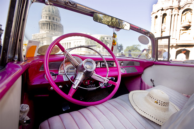 Car in Havana, Cuba (Photo: akturer/Shutterstock.com) Interior of a hot pink American car in Havana, Cuba with Capitol building in the background
