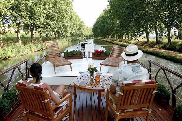 Relaxing on a barge canal cruise (Photo: Abercrombie & Kent) Relaxing on a barge canal cruise