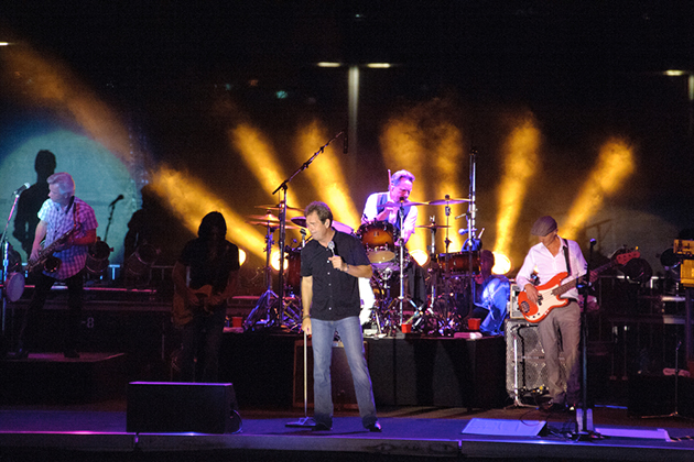 Huey Lewis & the News (Photo: Randy Miramontez/Shutterstock) Band playing on stage with purple and yellow lights