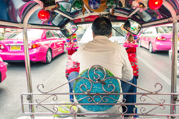 A Tuk Tuk taxi stopped in Bangkok traffic. (View Apart/Shutterstock) Tuk Tuk taxi