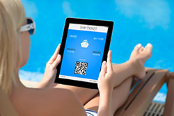 Book while on vacation - photo courtesy of Denys Prykhodov/Shutterstock Woman booking a cruise on a tablet