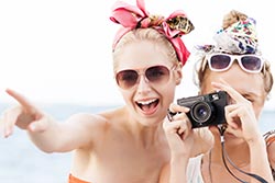 Friends taking a picture - photo courtesy of Nikkolia/Shutterstock Friends taking a picture - photo courtesy of Nikkolia/Shutterstock