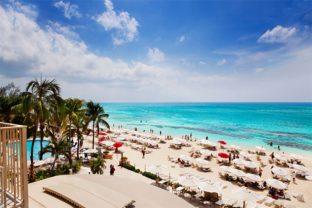 Vacationers on a beach in Grand Cayman (photo: Jo Ann Snover/Shutterstock) Vacationers on a beach in Grand Cayman