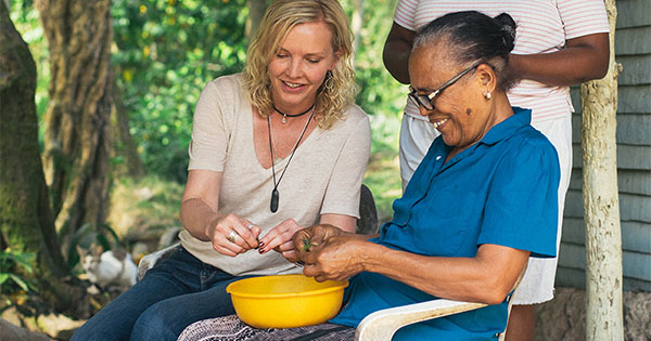 Social impact activity in the Dominican Republic (Photo: Fathom) Fathom passenger helping Dominican woman with chores