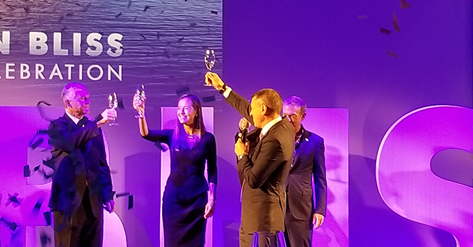 Norwegian Bliss Christening Ceremony (Photo: Colleen McDaniel, Senior Executive Editor) Four People Roasting Champagne on Violet Screen