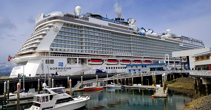 Norwegian Bliss Docked in the Port of Seattle (Photo: Colleen McDaniel, Senior Executive Editor) Cruise ship docked in the harbor with sailboats in the foreground